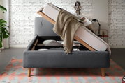 Stelbed met opgeklapt matras en opbergruimte, zijaanzicht