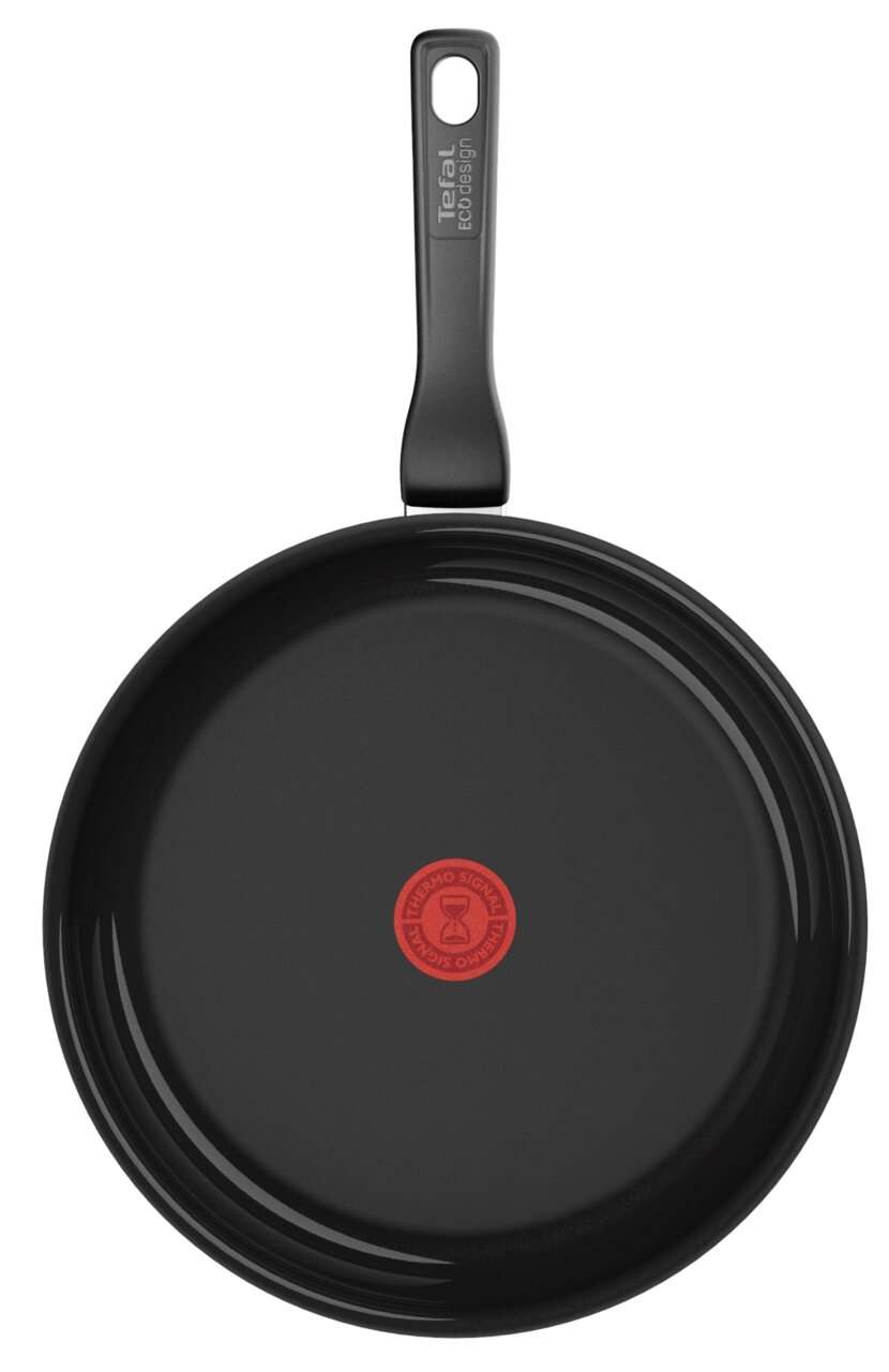Keramische pan met een diameter van 28 cm, zwart oppervlak, rode thermische markering in het midden, gezien van bovenaf.