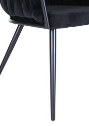 Nahaufnahme eines schwarzen Sessels mit Metallbeinen, seitliche Perspektive