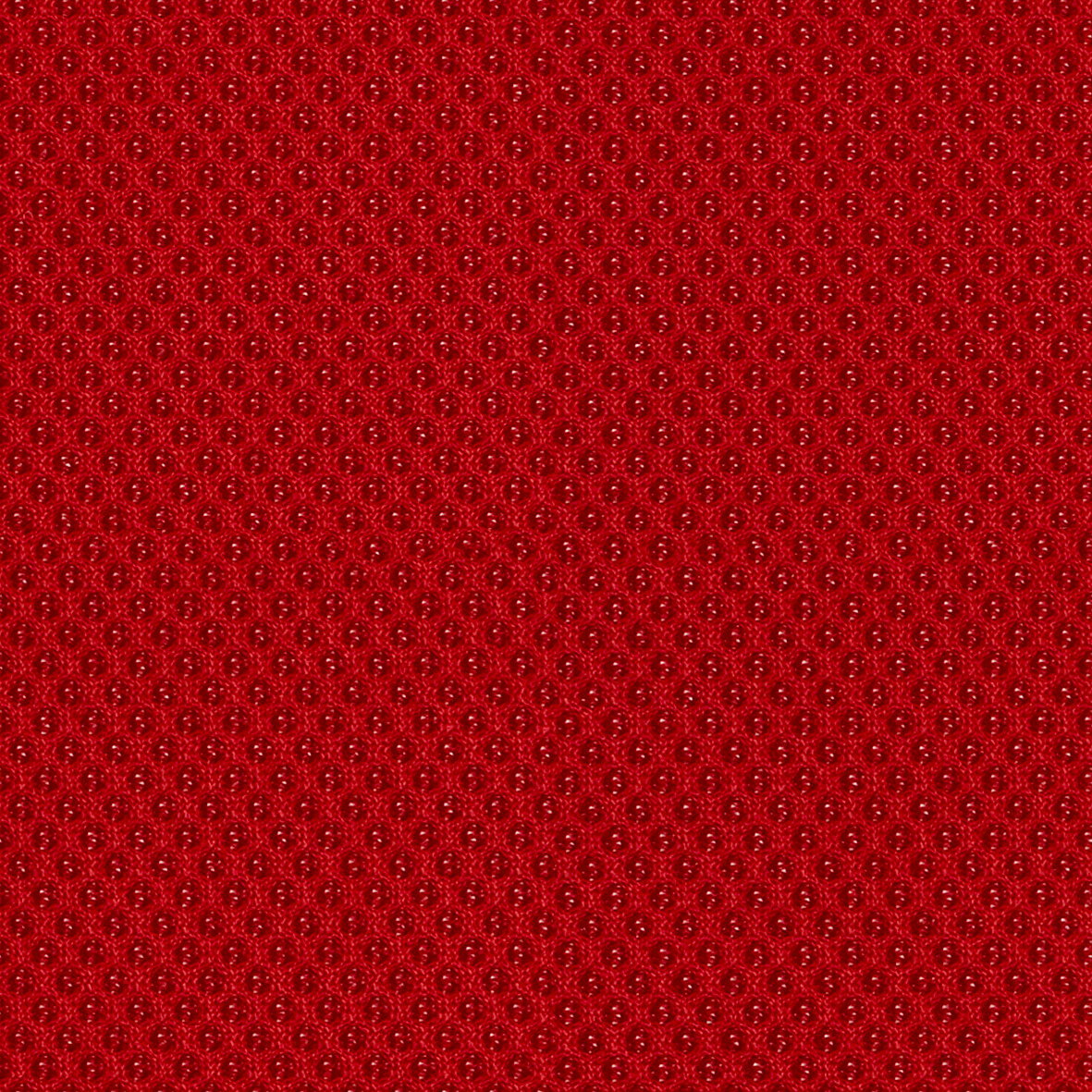 Nahaufnahme eines roten, strukturierten Stoffes mit gleichmäßigem Muster
