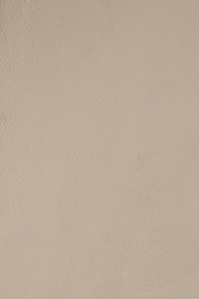 Nahaufnahme einer beigen Lederstruktur, von oben betrachtet.