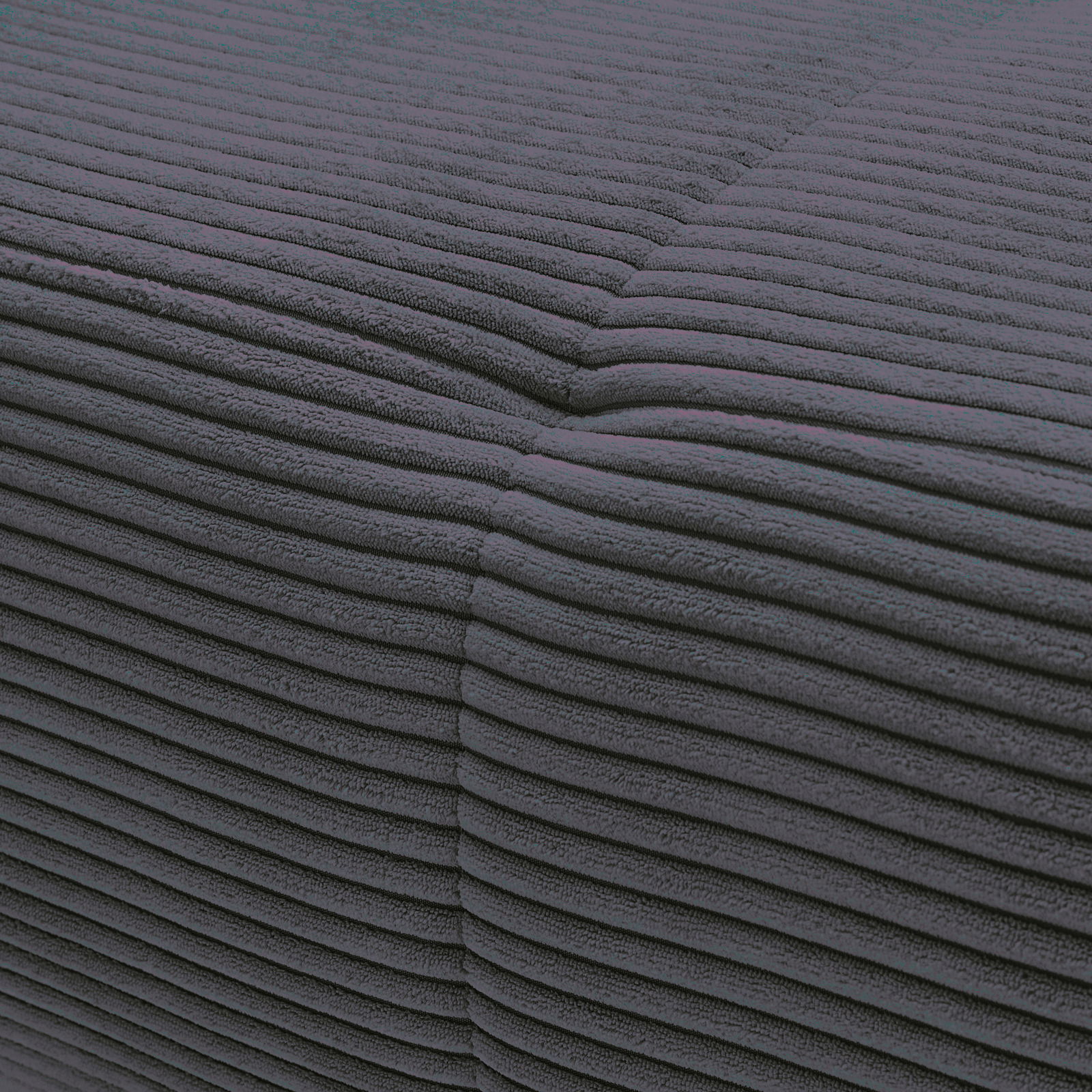 Nahaufnahme einer dunkelgrauen, gerippten Stoffoberfläche einer Rundecke aus der Perspektive einer Ecke.