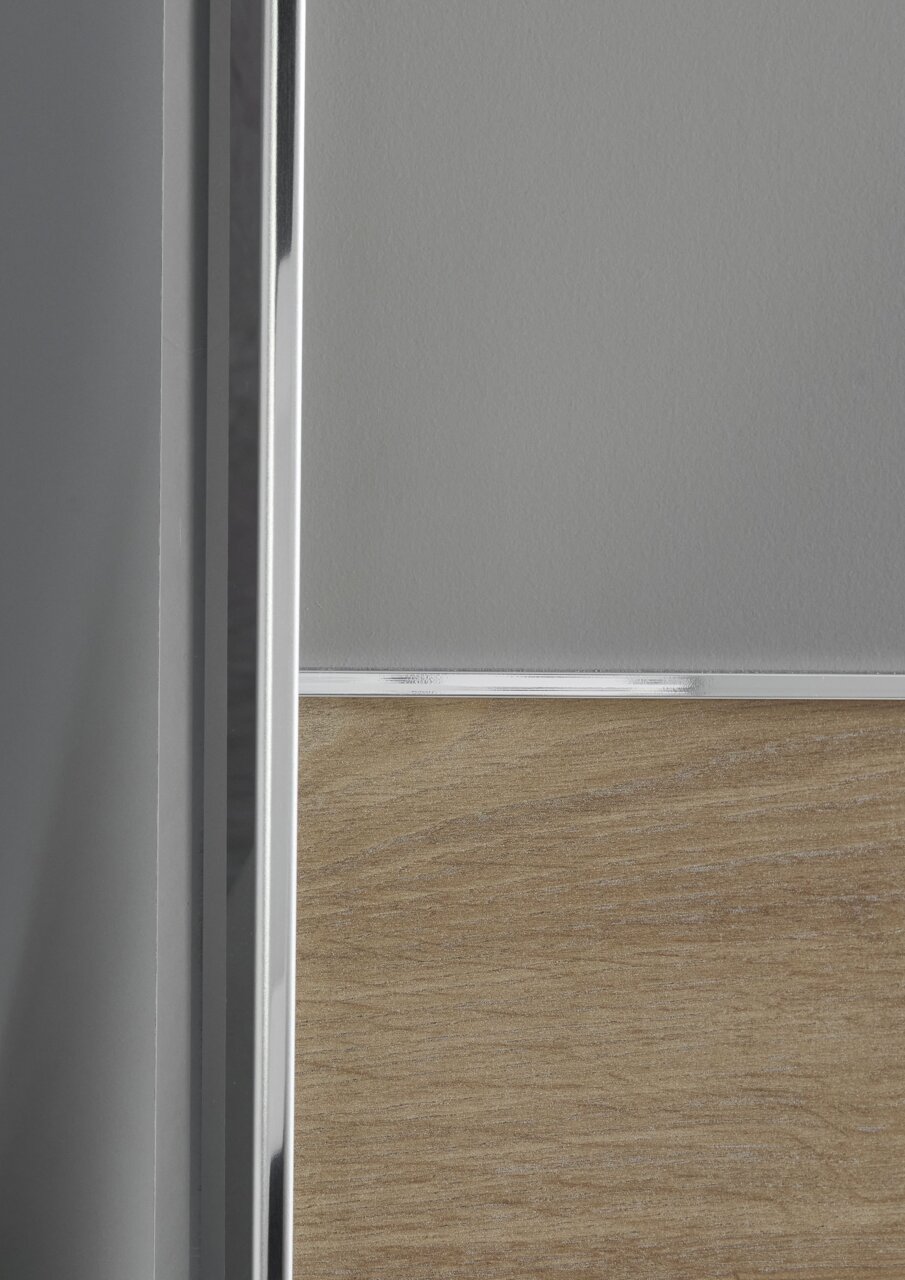 Nahaufnahme eines Schwebetürenschranks mit Holz- und Metallelementen, seitliche Perspektive.