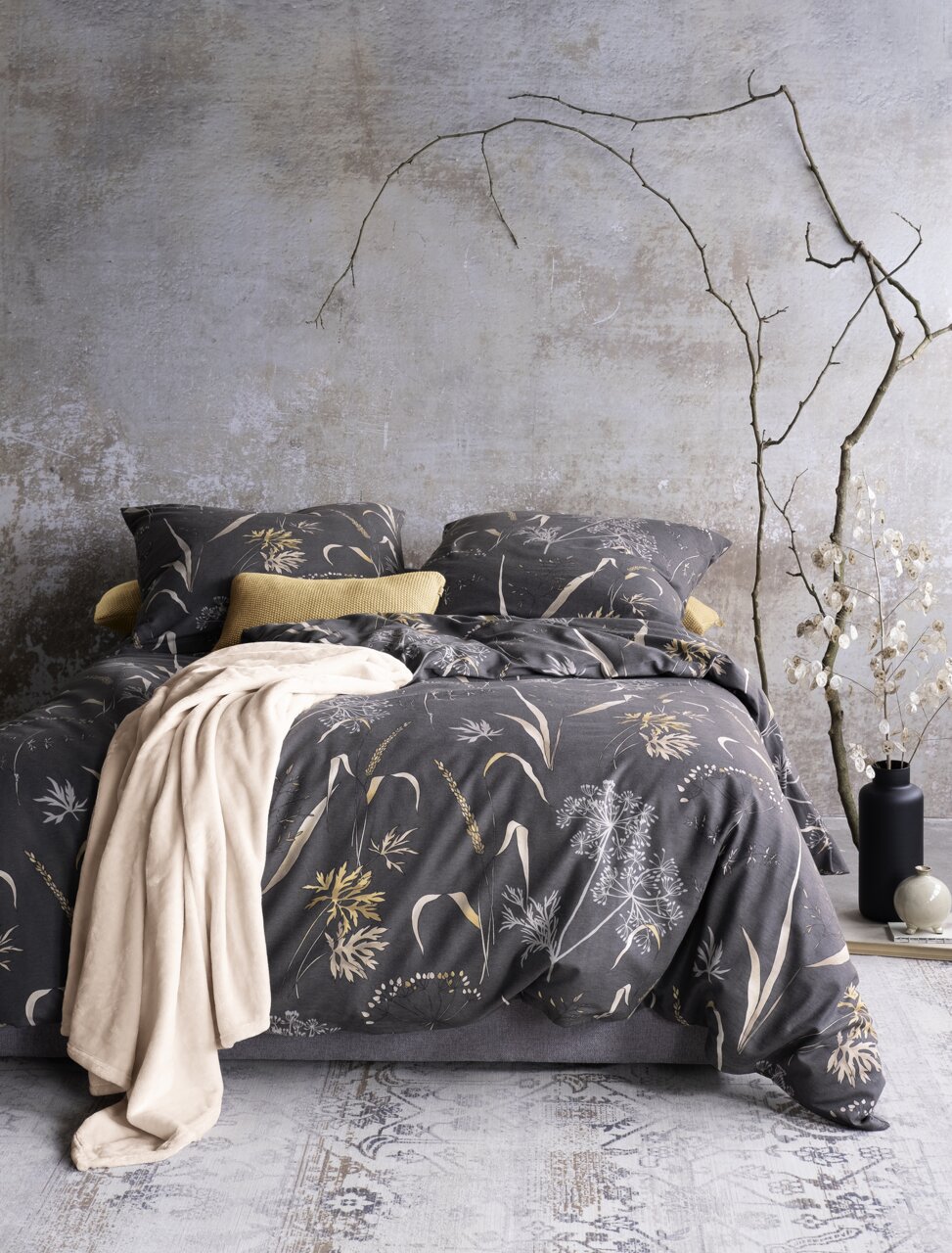 Bettwäsche-Set in 155x220cm mit floralem Muster in Grau- und Beigetönen, frontal fotografiert, dekoriert mit Kissen und Decke.