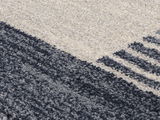 Nahaufnahme eines Frisé-Teppichs mit grauen und cremefarbenen Streifen, diagonale Perspektive.