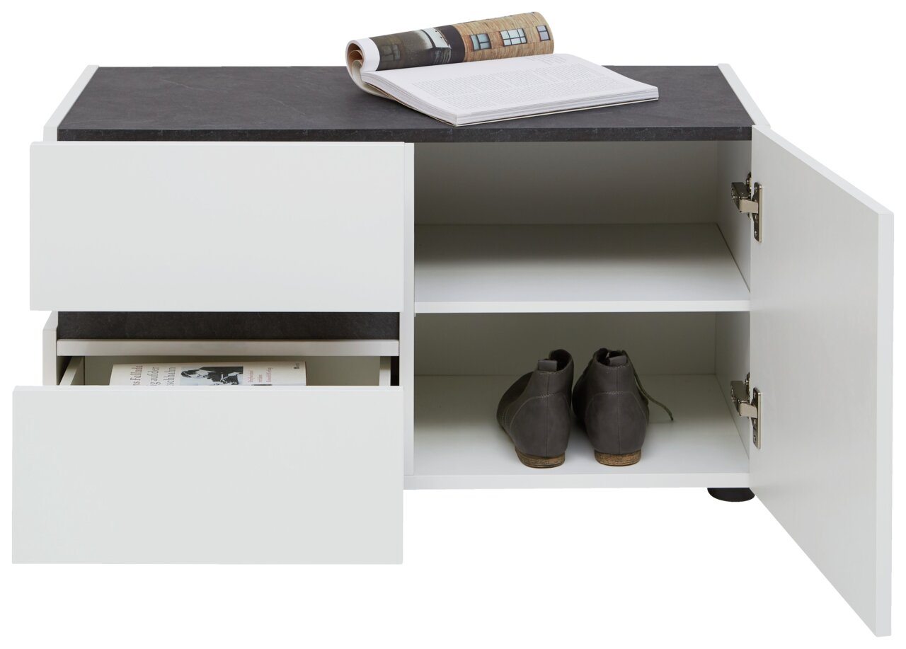 Weiße Bank mit schwarzer Oberfläche, zwei offenen Schubladen und einem offenen Fach mit Schuhen, aus frontaler Perspektive.