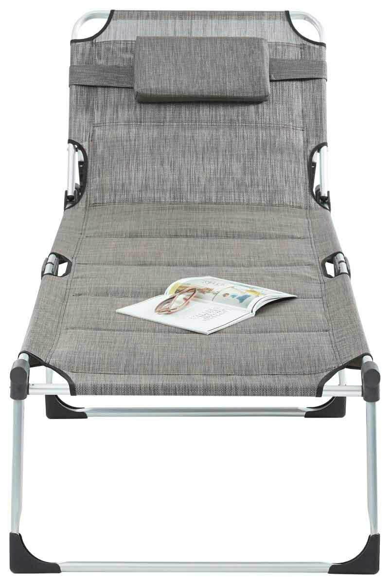 Graue Liege mit Kopfstütze und Magazin, frontal fotografiert.