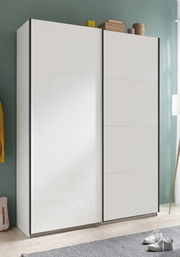 Moderner weißer Schwebetürenschrank mit zwei Türen, frontal fotografiert, in einem stilvoll eingerichteten Raum.