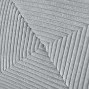 Close-up van een grijze, gestructureerde stof met diagonale lijnen op een functionele bank.