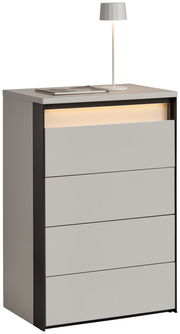 Hochkommode mit vier Schubladen, moderne graue Oberfläche, seitliche schwarze Akzente, mit Tischlampe und Buch auf der Oberseite, seitliche Perspektive