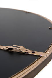 Rückansicht eines runden Spiegels mit Metallrahmen und Aufhängung, Nahaufnahme.