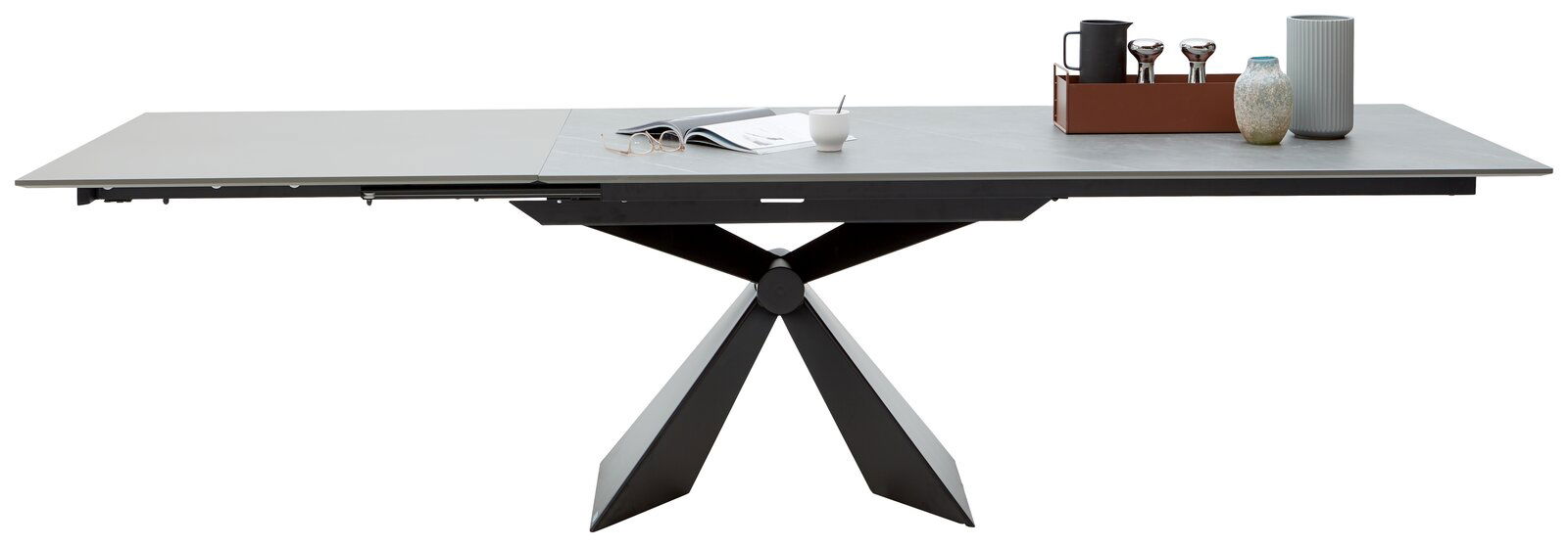 Moderner Esstisch mit ausziehbarer Tischplatte und geometrischem Metallgestell, seitliche Perspektive.