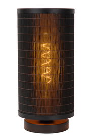 Zylindrische Tischlampe mit schwarzem, gitterartigem Schirm und warmem Licht, frontal aufgenommen.