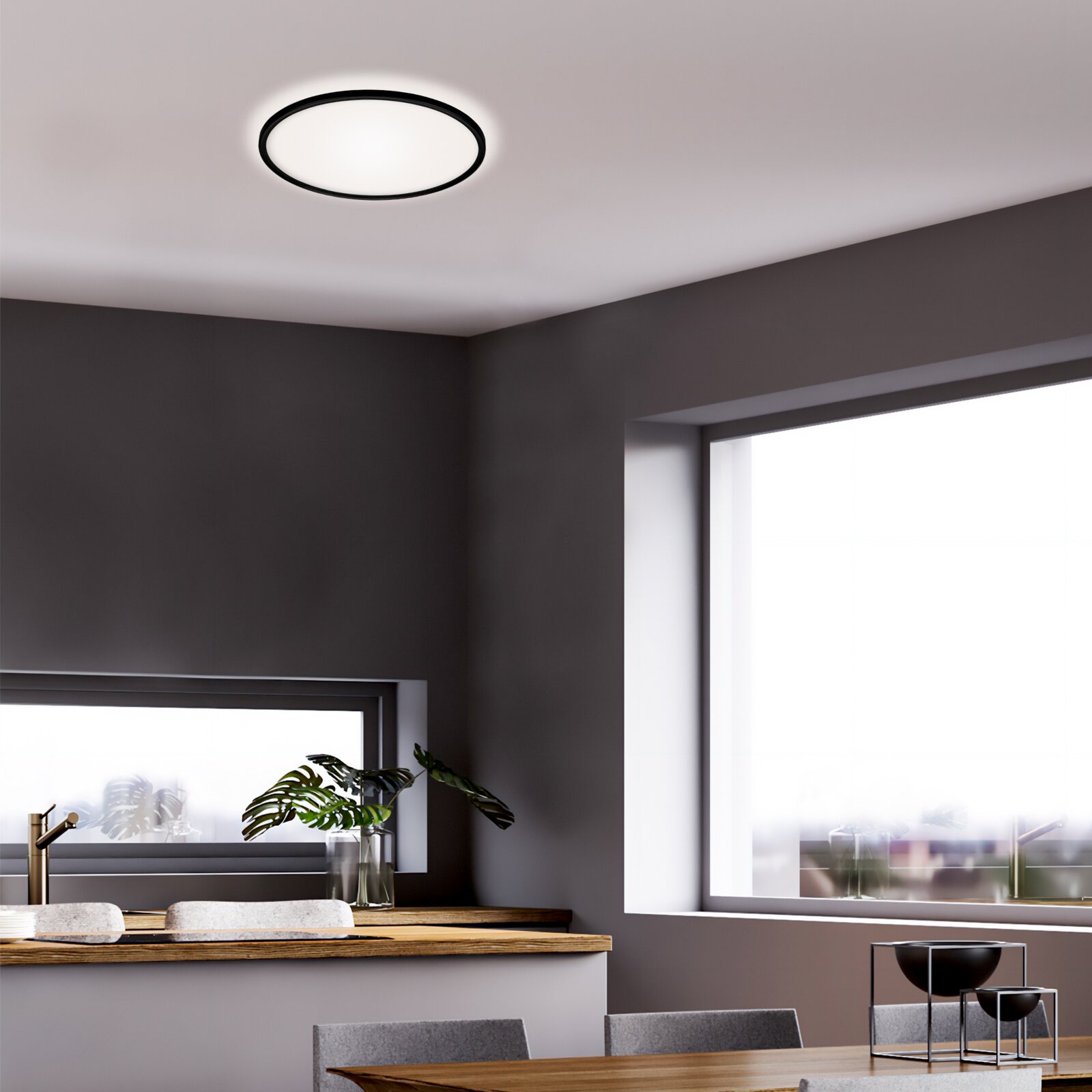 Moderne led-plafondlamp in een stijlvolle woonkamer, van onderaf gezien.