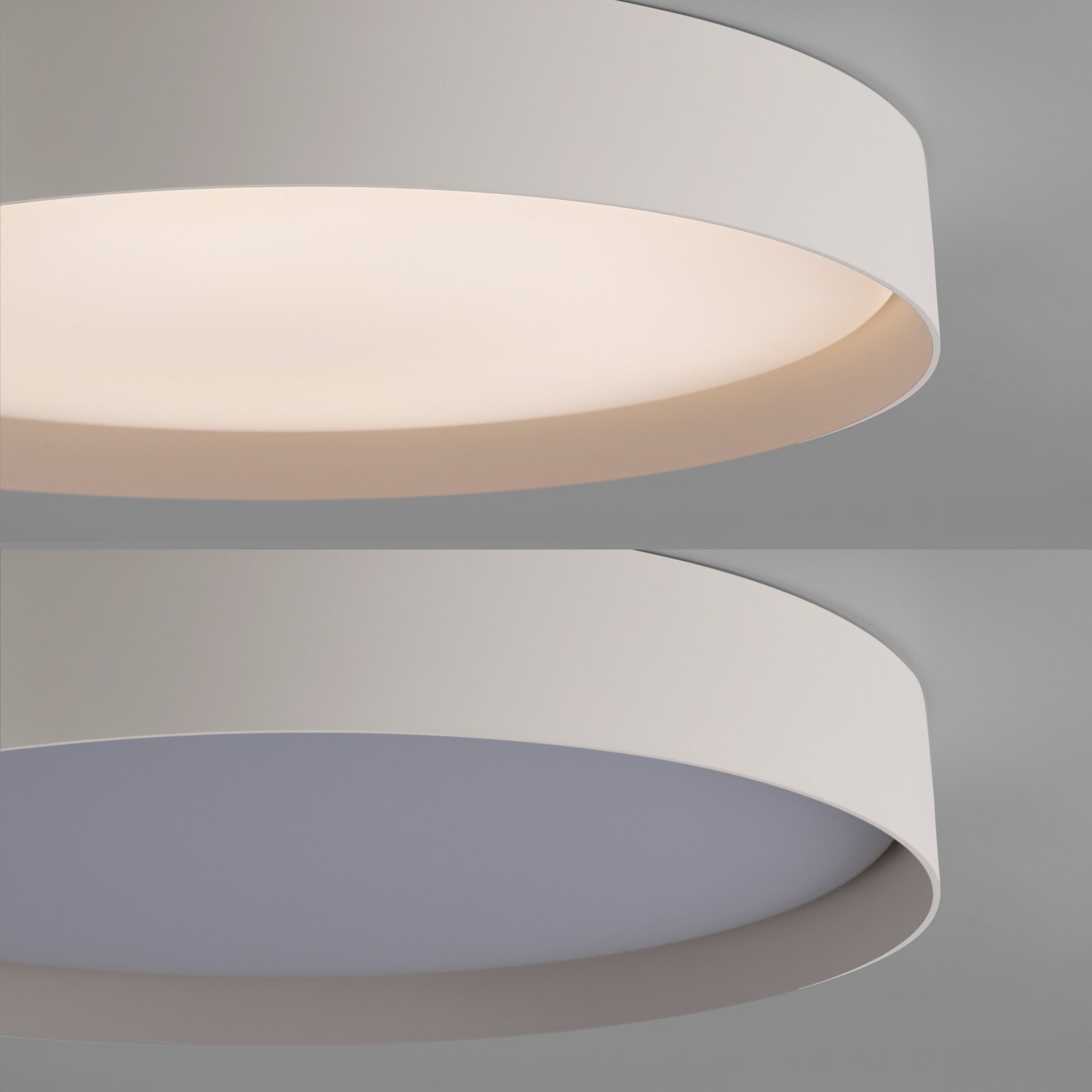 Moderne runde LED-Deckenleuchte in Weiß mit breitem Diffusor, warmweiß leuchtend, aus schräger Untersicht aufgenommen