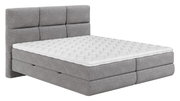 Grijs boxspringbed met gewatteerde witte topper, zijaanzicht