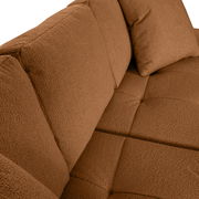 Nahaufnahme einer braunen Rundecke mit weicher Polsterung und Kissen, seitliche Perspektive