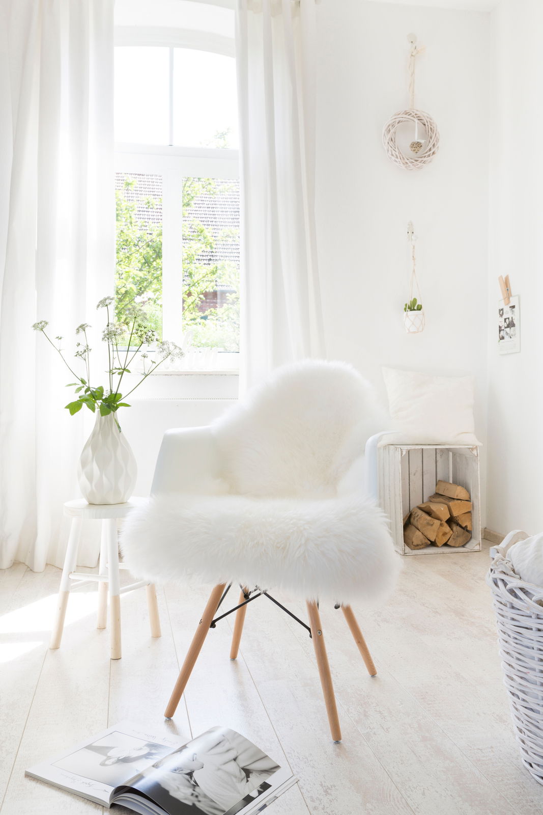 Zurbrüggen Schaffell ca. 85cm Weißes Schaffell auf einem modernen Stuhl in einem hellen, gemütlichen Raum mit Holzfußboden und natürlichem Licht von einem Fenster.