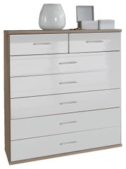 Weiße Schubkastenkommode mit mehreren Schubladen, dekoriert mit einer Vase und Schmuckkästchen, aus frontaler Perspektive.