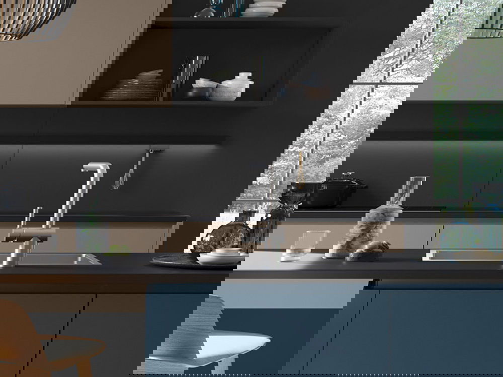 Moderne dunkle Küche mit einem eleganten silbernen Wasserhahn und einer dunklen Arbeitsplatte.