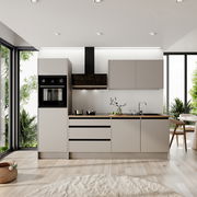 Moderne Küchenzeile in einem hellen Raum mit großen Fenstern, ohne Elektrogeräte, mit grauen Schränken und Holzarbeitsplatte, seitliche Perspektive.