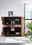 Geöffnetes Highboard aus Holz mit dekorativen Elementen, frontal fotografiert.