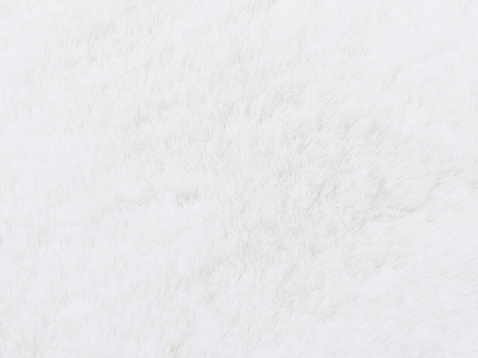 Nahaufnahme eines weißen Fellteppichs mit weicher Textur