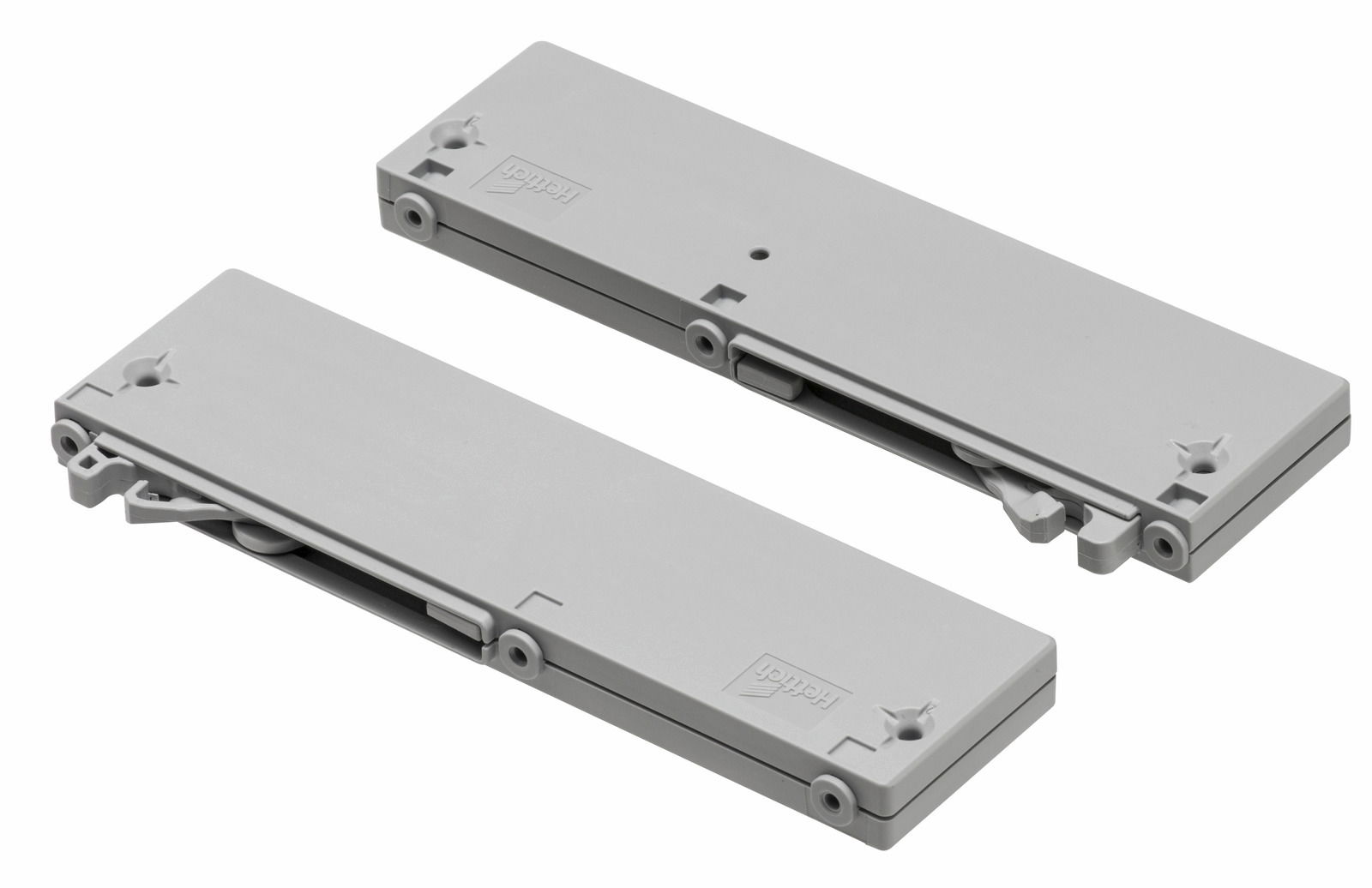 Zwei graue Dämpfer in rechteckiger Form, von oben betrachtet, mit sichtbaren Befestigungspunkten und Mechanismen.