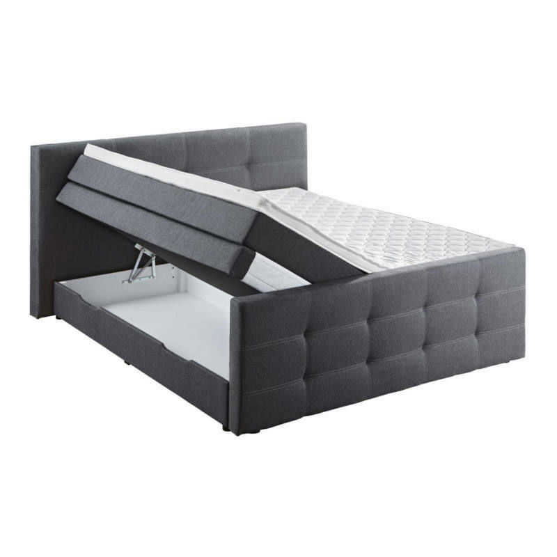 Graues Boxspringbett mit hochgeklappter Matratze und sichtbarem Stauraum, seitliche Perspektive