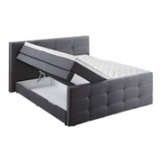 Grijs boxspringbed met opklapbaar matras en zichtbare opbergruimte, zijaanzicht