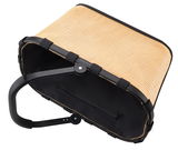 Tragetasche aus geflochtenem Material mit schwarzem Rahmen und Griff, von oben betrachtet.