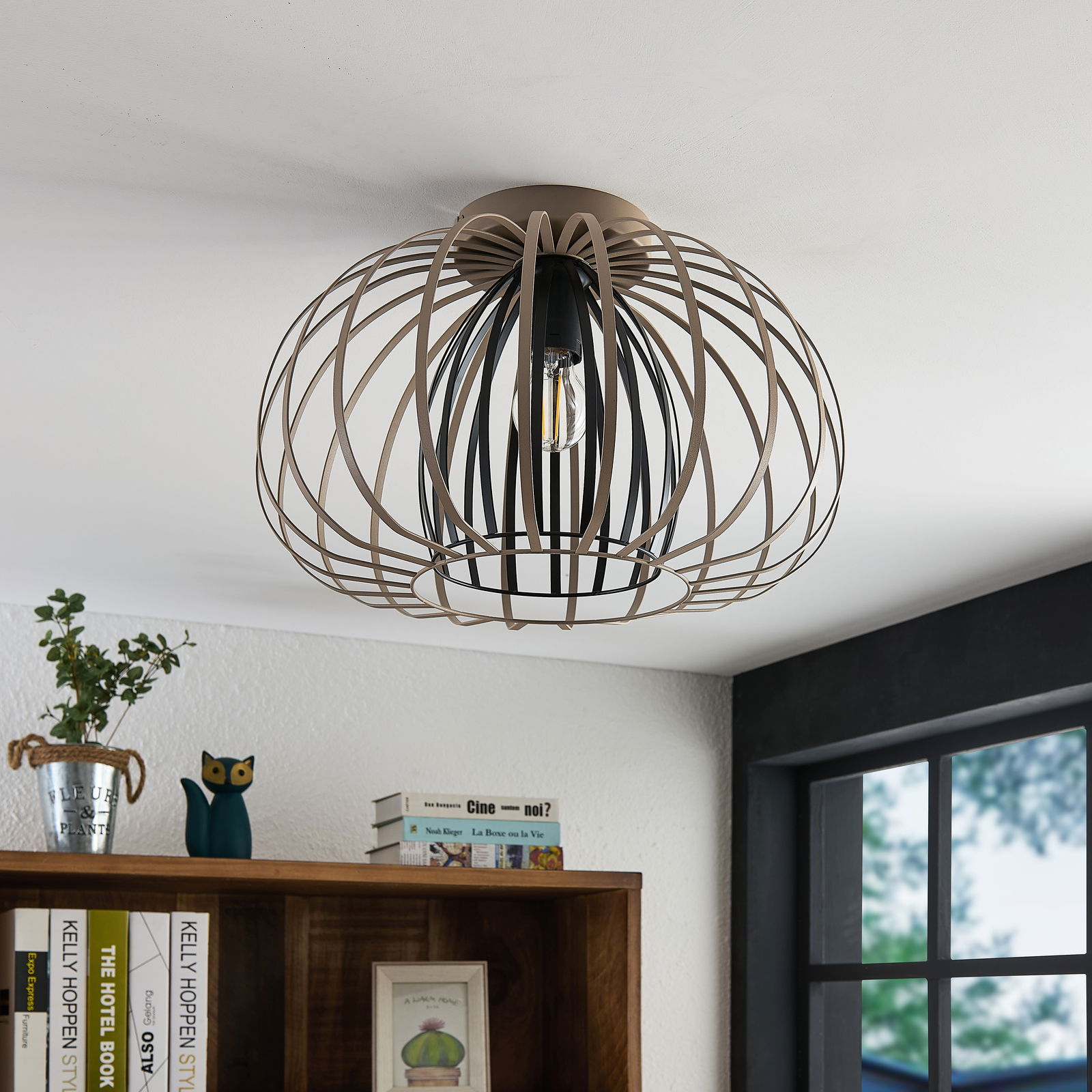 Moderne Deckenleuchte mit einem offenen, kugelförmigen Metallrahmen, von unten betrachtet.