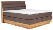 Boxspringbett mit braunem Polster und Holzrahmen, seitliche Perspektive