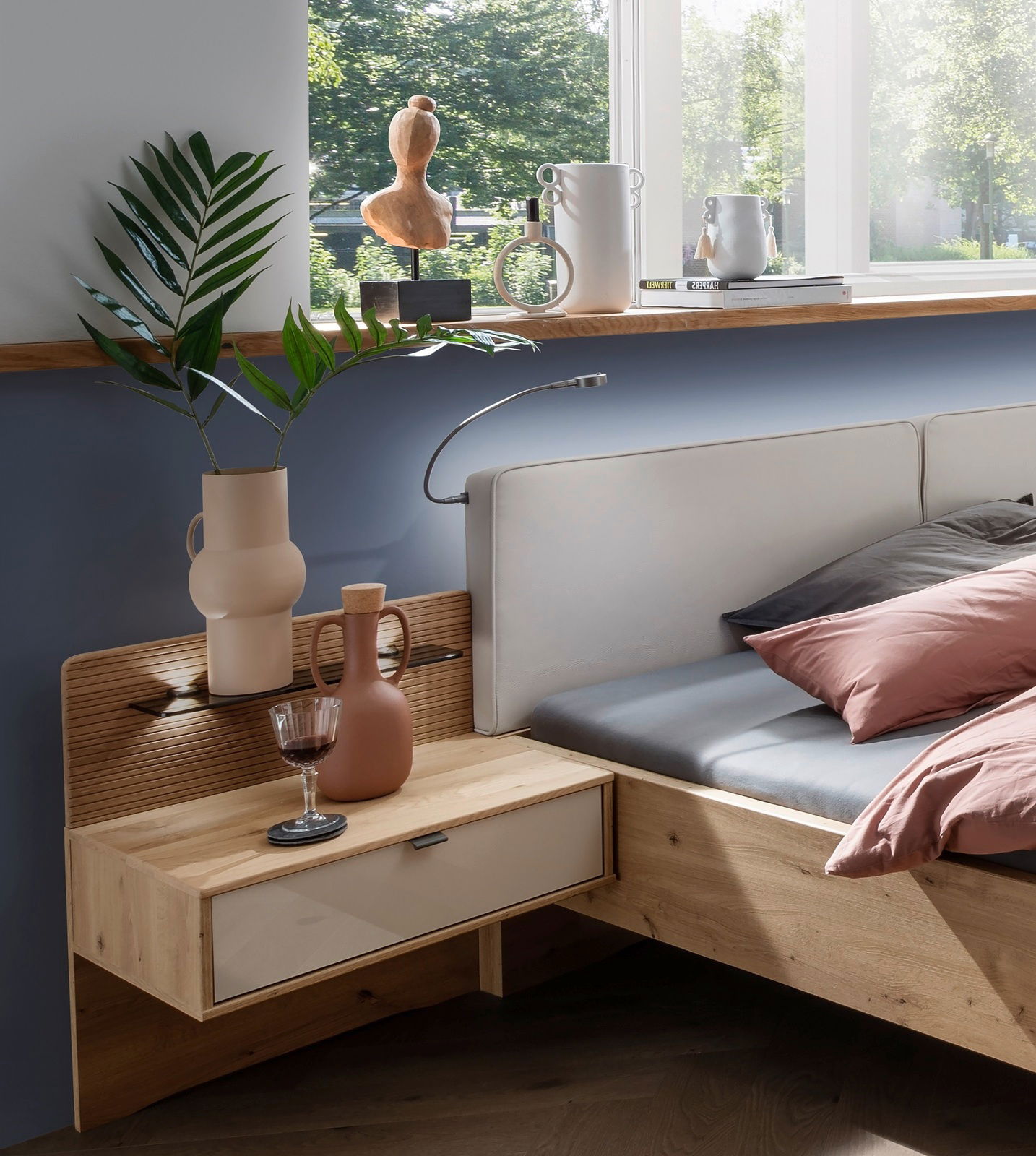 Venda Nachtschrank (Paar) NEW YORK Moderner Nachtschrank aus Holz mit Schublade, dekoriert mit Vasen und einem Weinglas, seitliche Perspektive.