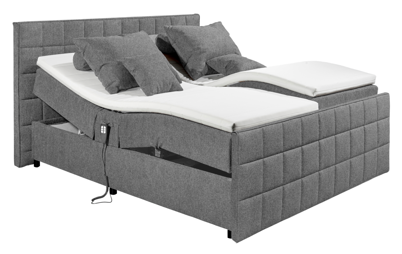 Graues Polsterbett mit verstellbaren Matratzen und mehreren Kissen, seitliche Perspektive