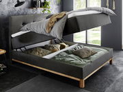 Boxspringbett mit hochgeklappter Matratze und Stauraum darunter, seitliche Perspektive