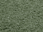 Nahaufnahme eines weichen, grünen Teppichs mit flauschiger Textur, Draufsicht.