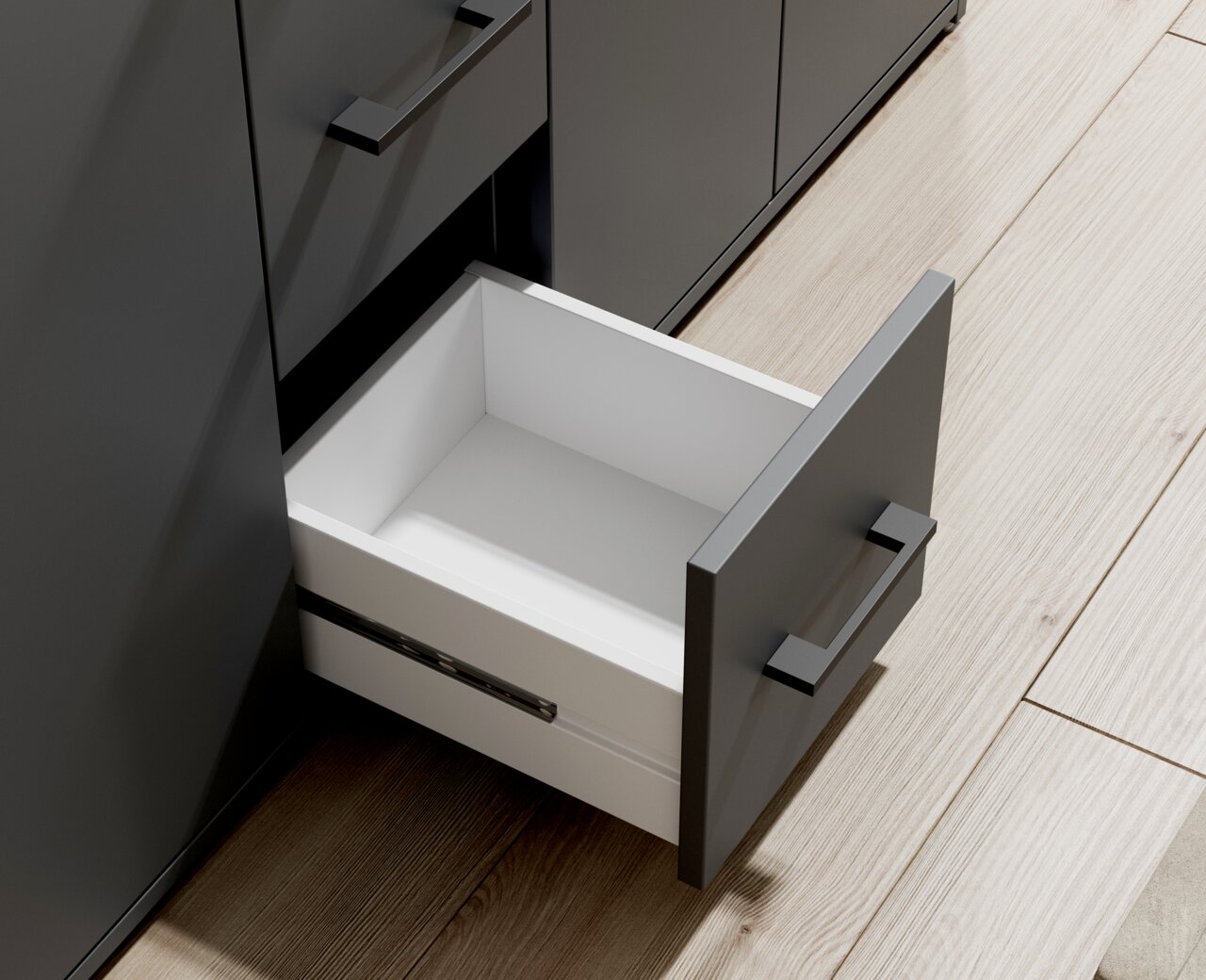 Geöffnete Schublade eines modernen, grauen Sideboards aus der Vogelperspektive.