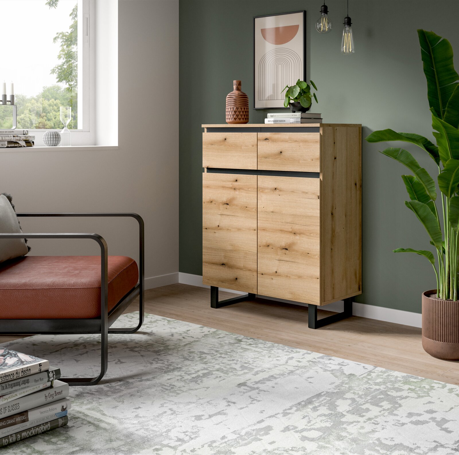 MID.YOU Kommode TOMASA Holzkommode mit zwei Schubladen und zwei Türen, in einem modernen Wohnzimmer mit grüner Wand, Pflanzen und Dekorationen, seitliche Perspektive
