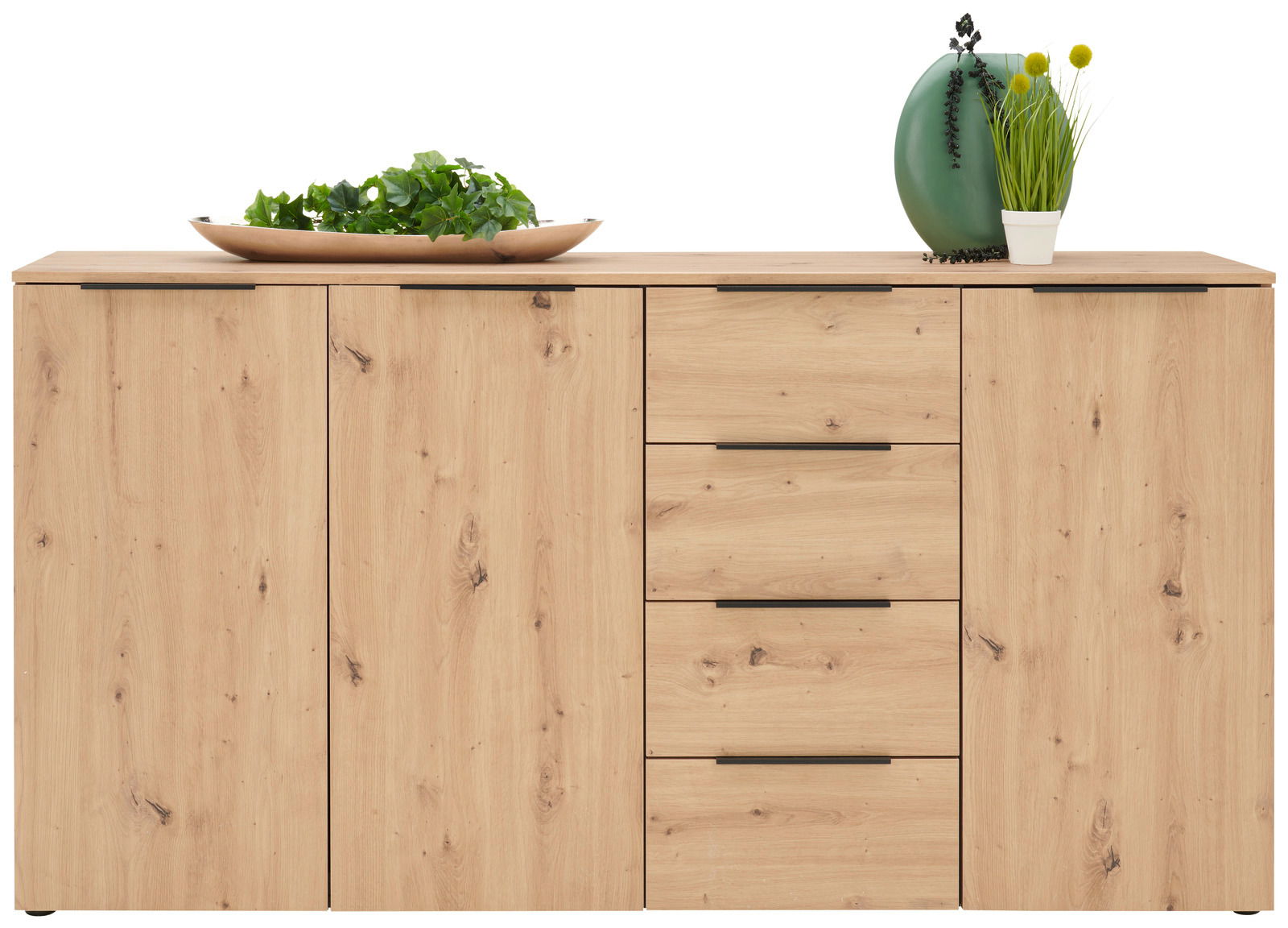 Frontale Ansicht eines XL-Sideboards aus hellem Holz mit zwei Türen und vier Schubladen, dekoriert mit einer Schale mit Pflanzen und einer grünen Vase.