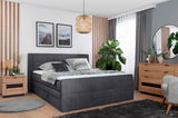 Modernes Boxspringbett 160 in einem stilvoll eingerichteten Schlafzimmer, seitliche Perspektive