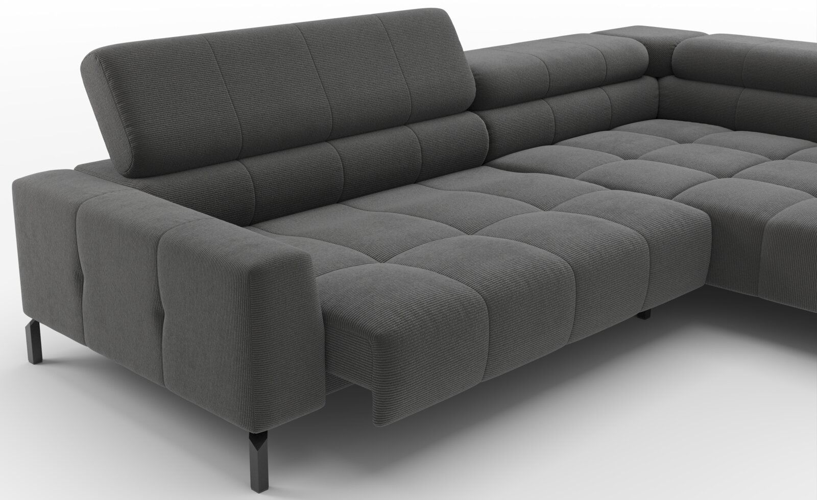 Donkergrijze ribfluwelen hoekbank met chaise longue en gecapitonneerde kussens, schuin van voren links bekeken
