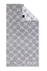 Graues Handtuch mit geometrischem Muster und JOOP!-Logo, von oben fotografiert.
