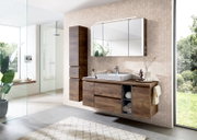 Modernes Badmöbel-Set in Holzoptik mit wandhängendem Waschtischunterschrank, Aufsatzwaschbecken, hohem Hochschrank und großem Spiegelschrank mit LED-Leuchte, aufgenommen in frontaler Perspektive mit leichter Seitenansicht.