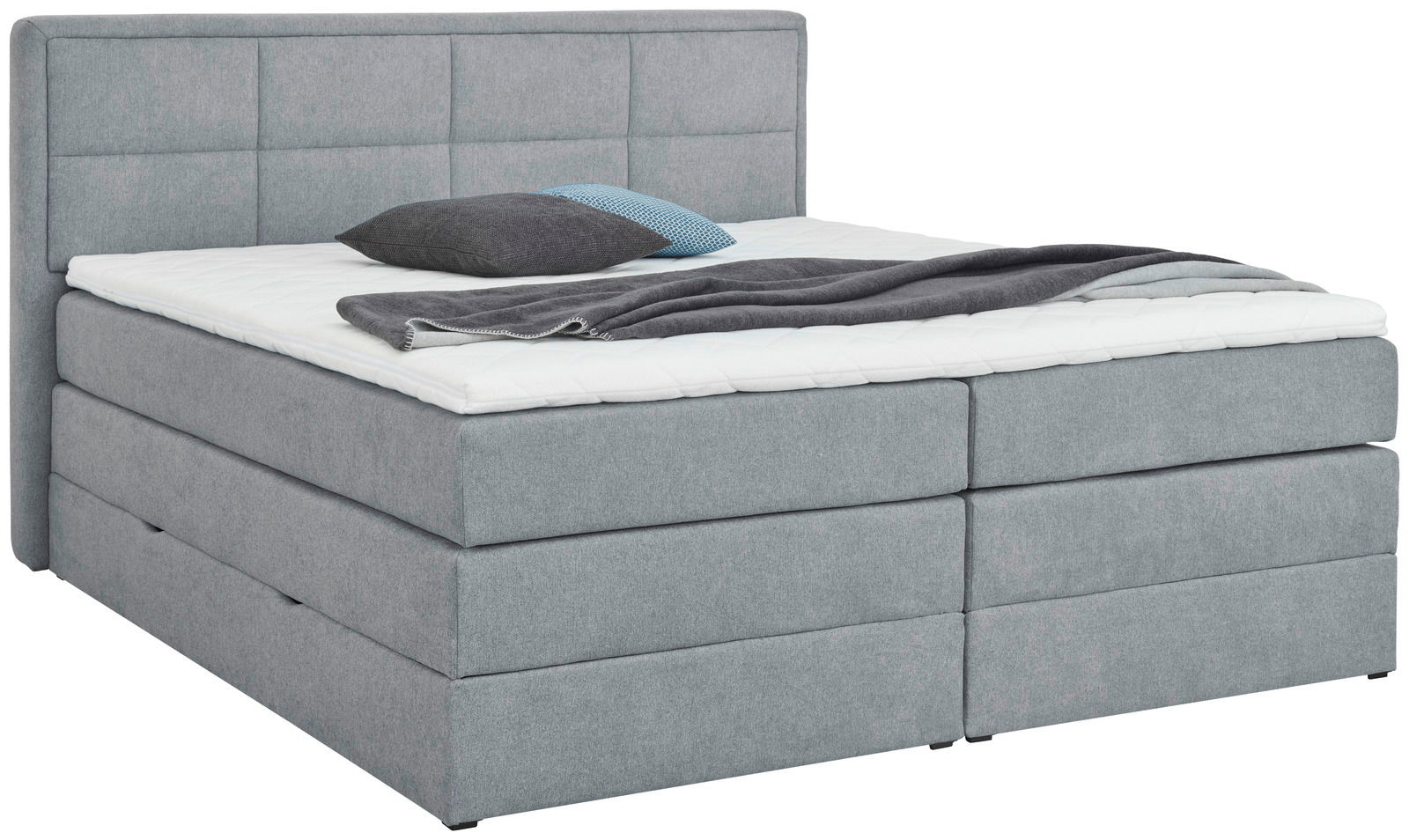 Graues Boxspringbett mit Kopfteil, seitliche Perspektive, mit Kissen und Decke dekoriert.