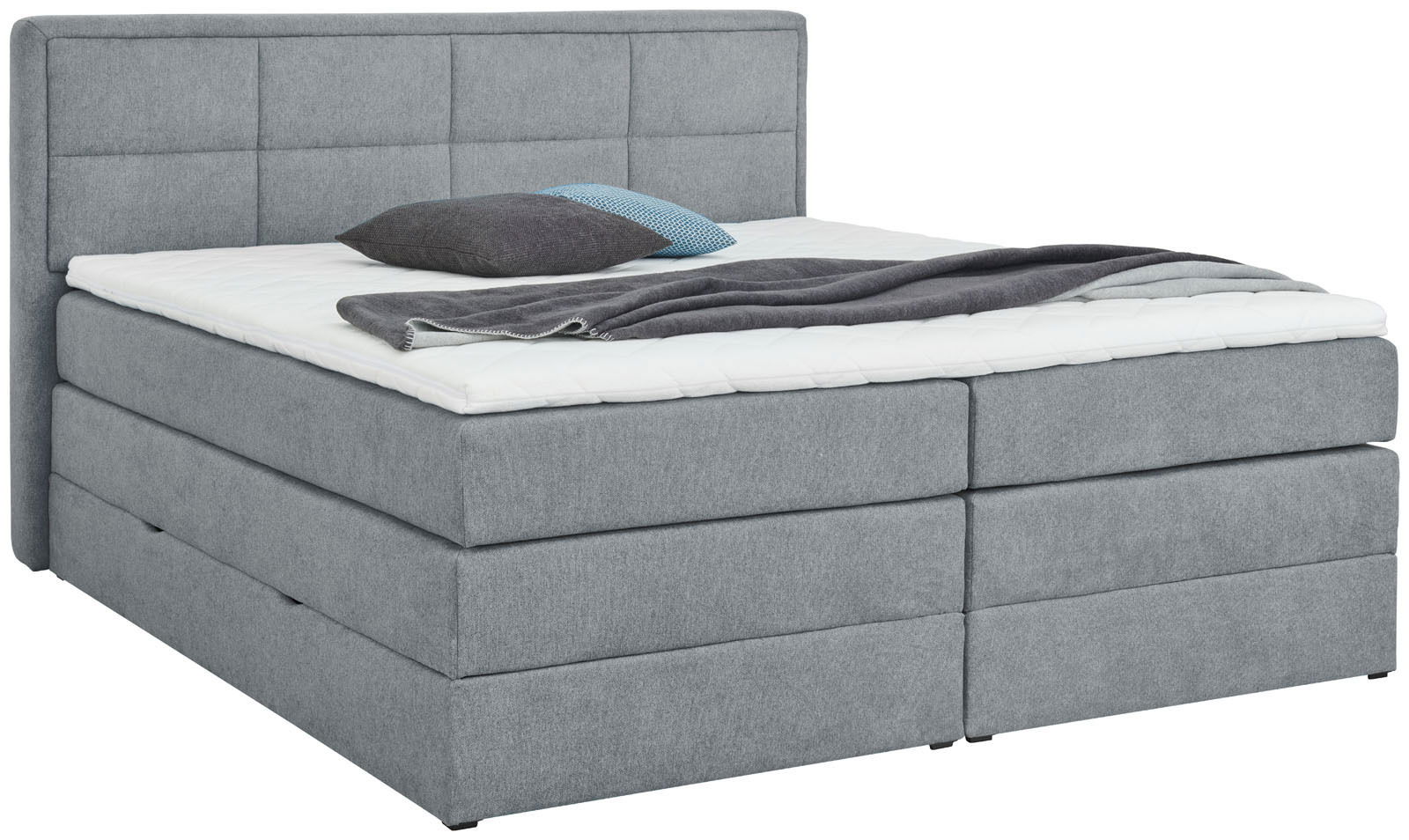 Graues Boxspringbett mit Kopfteil, seitliche Perspektive, mit Kissen und Decke dekoriert.