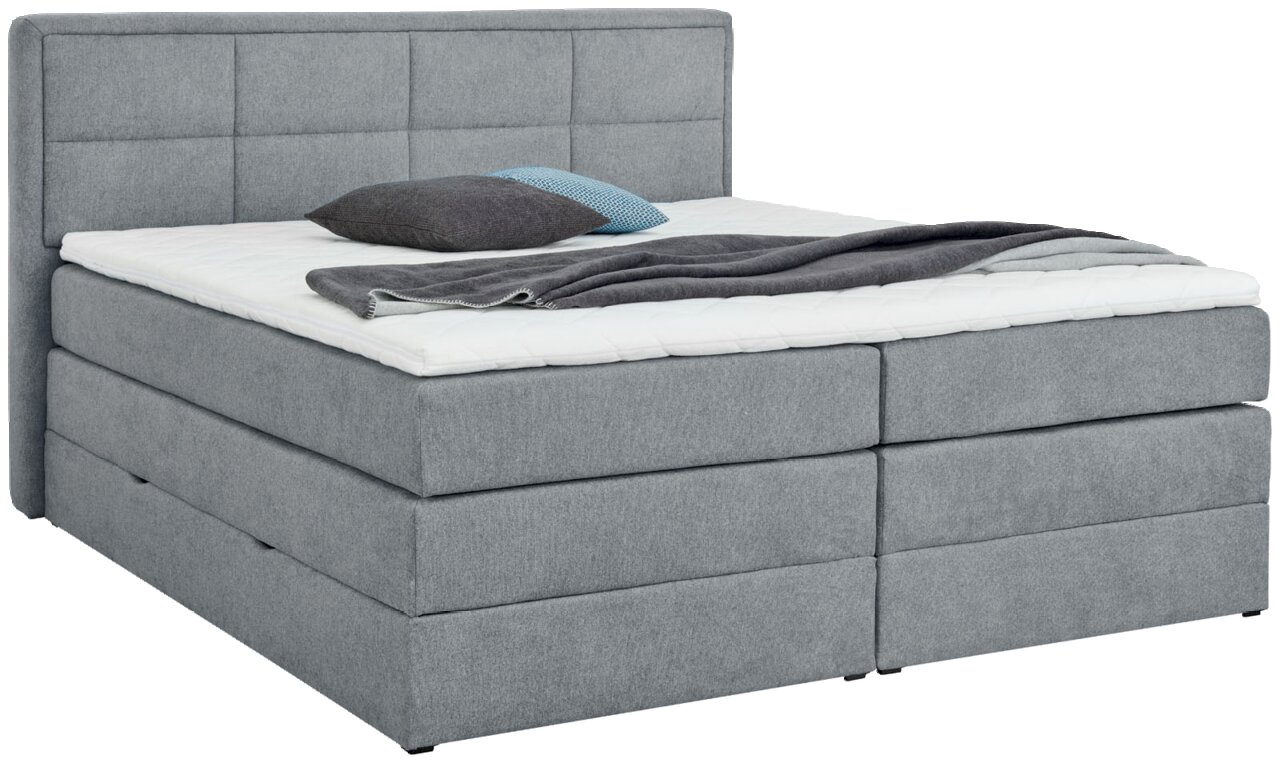 Z2 Boxspringbett ORLANDO Graues Boxspringbett mit Kopfteil, seitliche Perspektive, mit Kissen und Decke dekoriert.