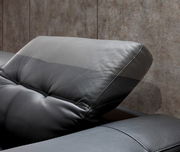 Nahaufnahme eines verstellbaren Kopfstütze eines schwarzen Ledersofas, seitliche Perspektive.