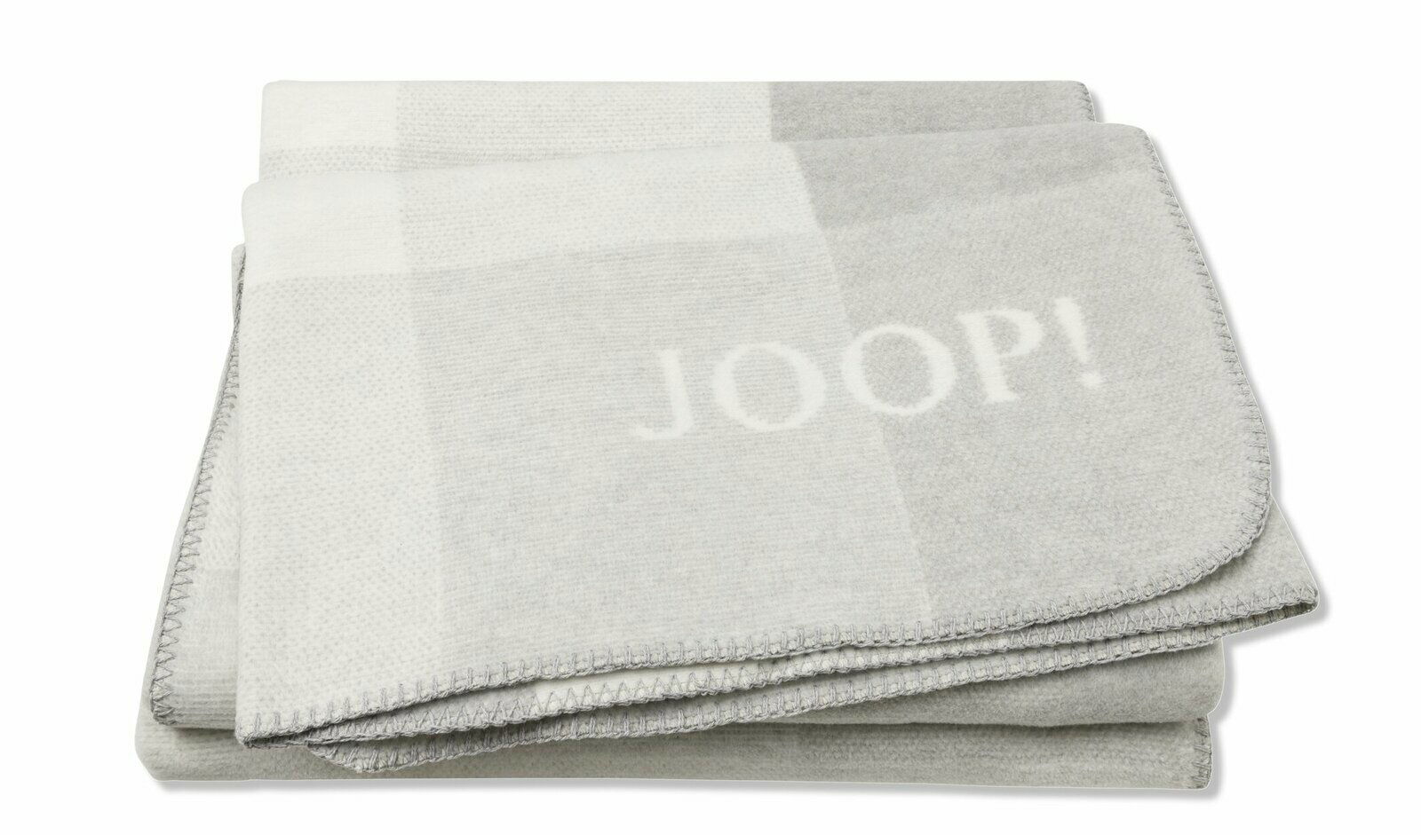 JOOP! Wohndecke J! Mesh Graue Decke mit dem Schriftzug 'JOOP!' in gefalteter Perspektive