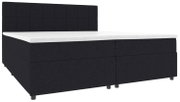 Schwarzes Boxspringbett mit gepolstertem, quadratisch abgestepptem Kopfteil und weißer Matratzenauflage, gezeigt in seitlicher Frontansicht (Perspektive leicht von vorne links).